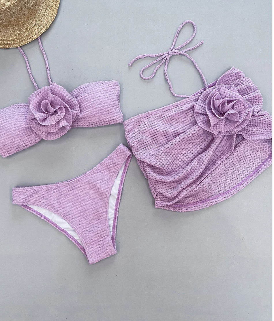 Close-up of the Italia Couture 'Victoria' bikini, showcasing a crochet floral design in a matching three-piece set.