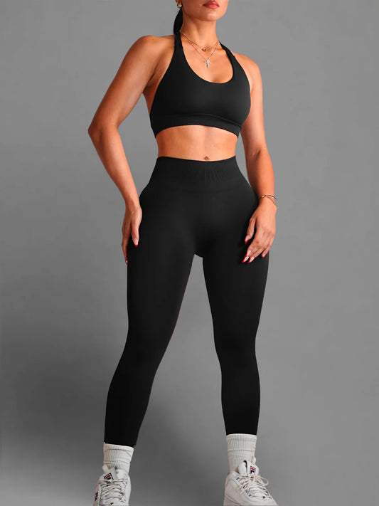 Person wearing a black sports bra and leggings set on a gray background