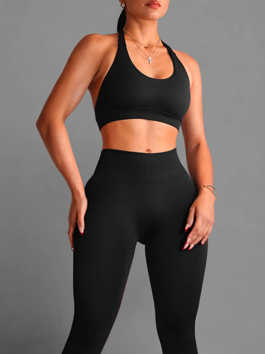Person wearing a black sports bra and leggings on a gray background