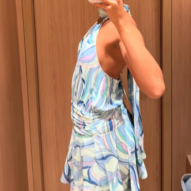 Person wearing a colorful patterned dress against a wooden background