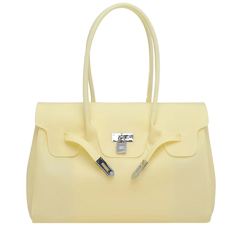 Yellow Jelly Firkin Bag with a silver clasp on a white background
