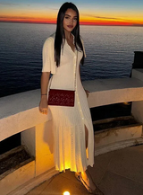 Fitted Knit Butterfly Button Maxi Dress worn by a woman on a sunset background