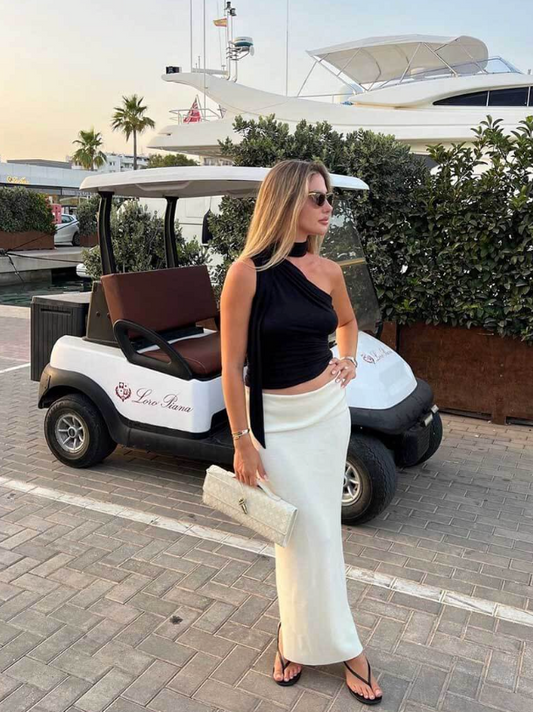 Woman in black top and white skirt standing in front of a golf cart with 'Lover's Avenue' branding.