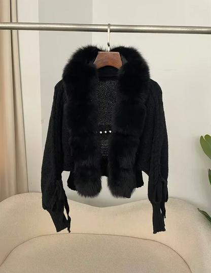 Black fur jacket with a hanger on a white background