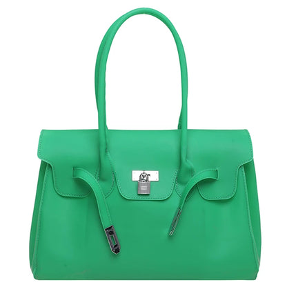 Green Jelly Firkin Bag with a silver clasp on a white background